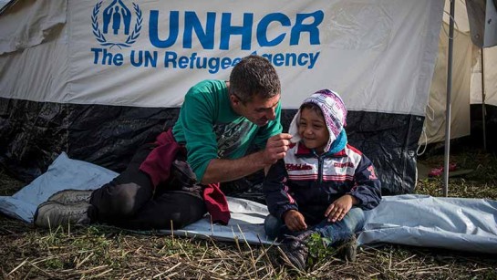 Mahmoud är syrisk flykting från Aleppo. Här lekar han med sin fyraåriga son Jawad utanför sitt tält där de bor med sin familj vid gränsen mellan Ungern och Serbien. Tusentals flyktingar passarade gränsen varje dag under höstan 2015.
